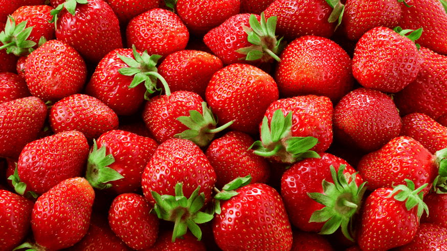 Bright red whole strawberries with green tops